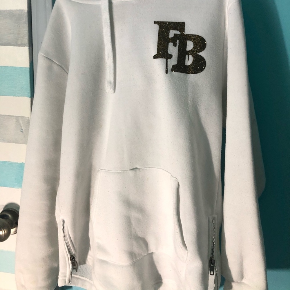 White sweater with gold FB letters